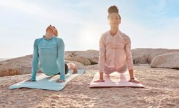 Yoga, fitness and friends on the beach together for mental health, wellness or meditating in summer